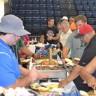 Coaches, players, and family members dig in at the annual All Star Hamburger Feed.